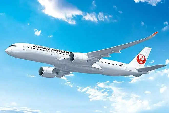 Japan Airlines aircraft flying through a clear blue sky