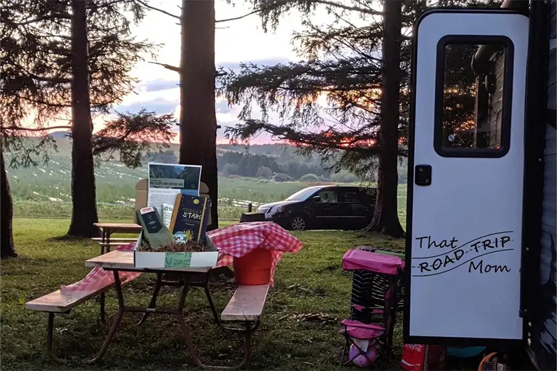 A campground set up with accessories and gear featured in the That Road Trip Mom's Escape and Explore Box subscription box for travelers