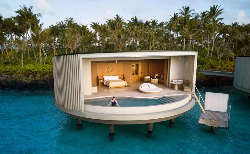 Woman looking out from an overwater villa