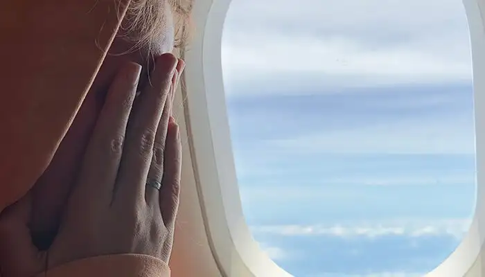 Close up of nervous woman on airplane