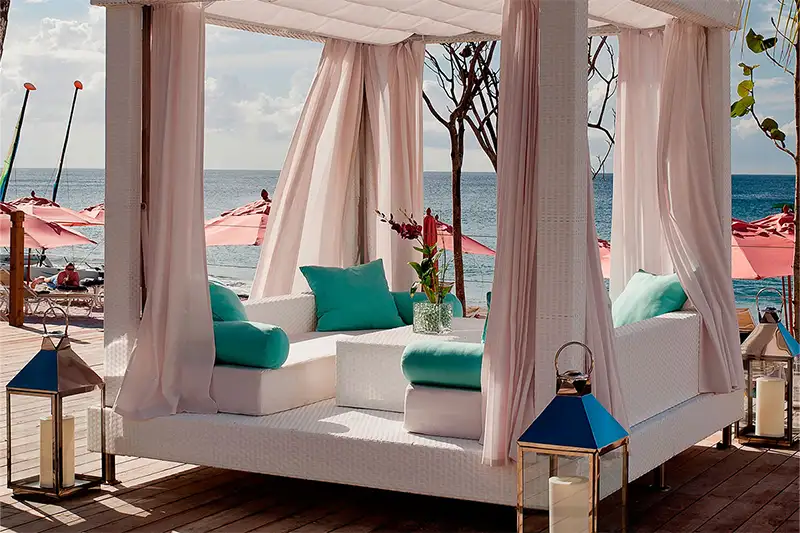 Outdoor lounge area with canopy on the beach at BodyHoliday, St. Lucia