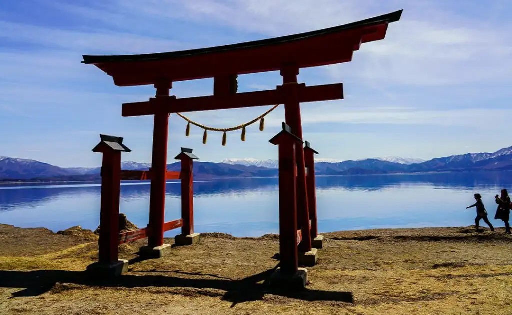 Beautiful view of the Gozanoishi Shrine on the shore of Lake Tazawa in Semboku, Akita, Japan