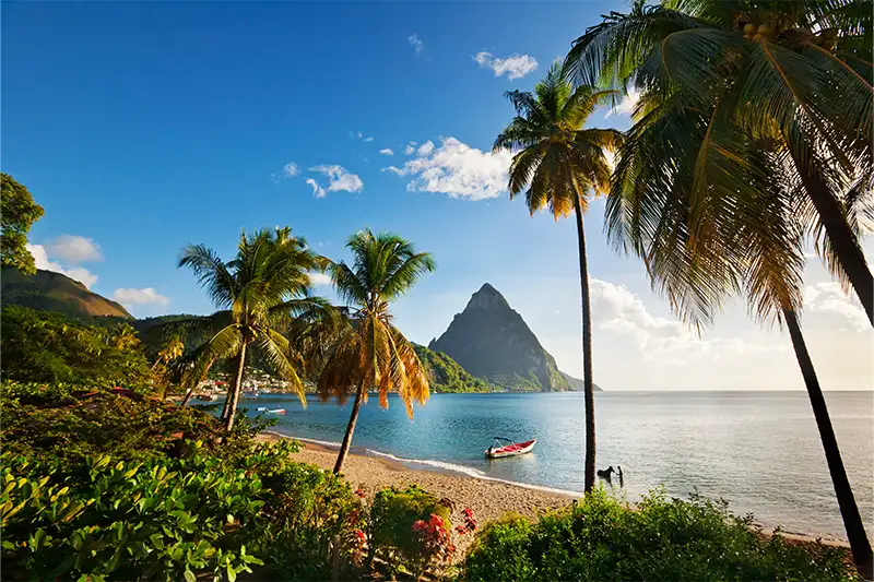 A beach on St. Lucia with the Pitons in the background at sunset