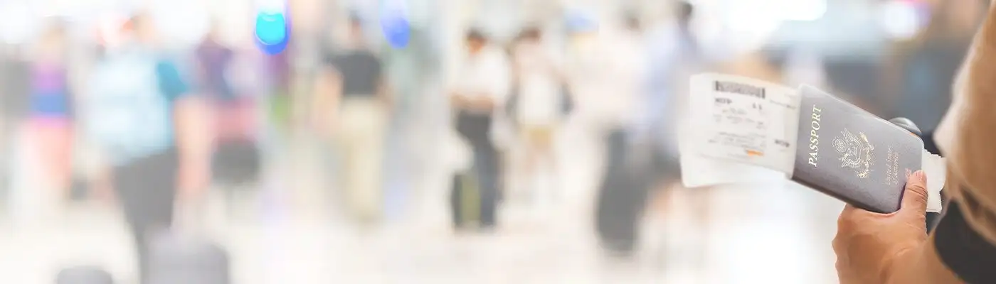 Closeup of girl holding passports and boarding pass at airport , panorama