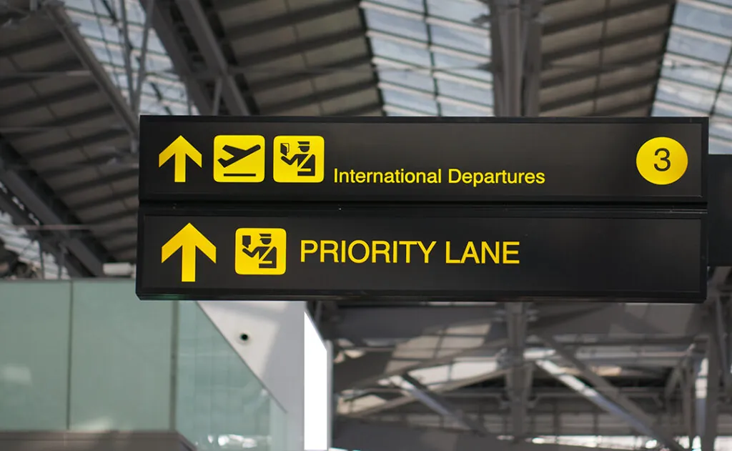 Departure and priority lane board sign at international airport