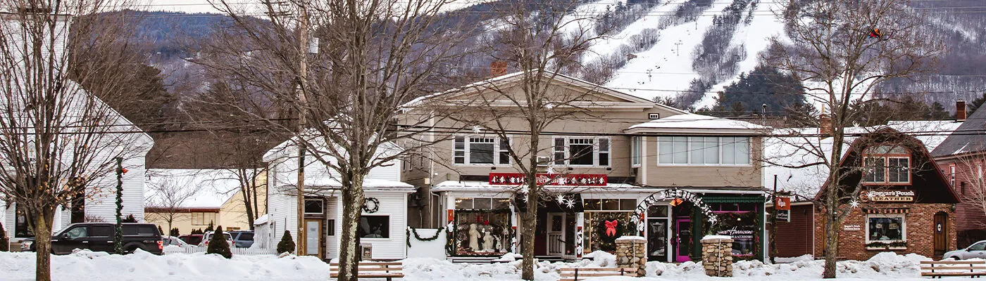 Church and store fronts with Cranmore Mountain Resort in the background