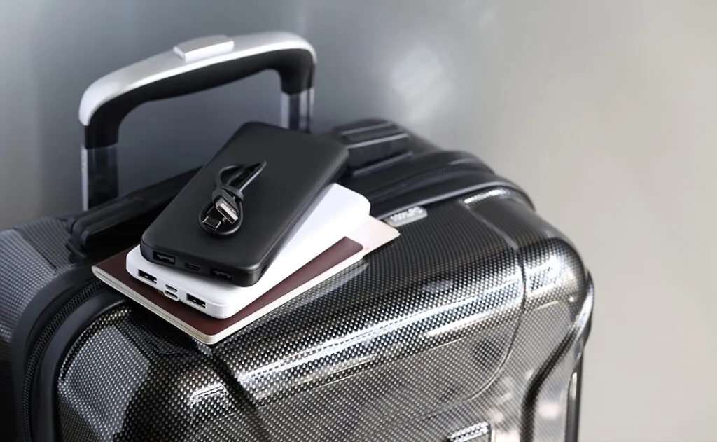 Power bank and passport on luggage for travel of holiday