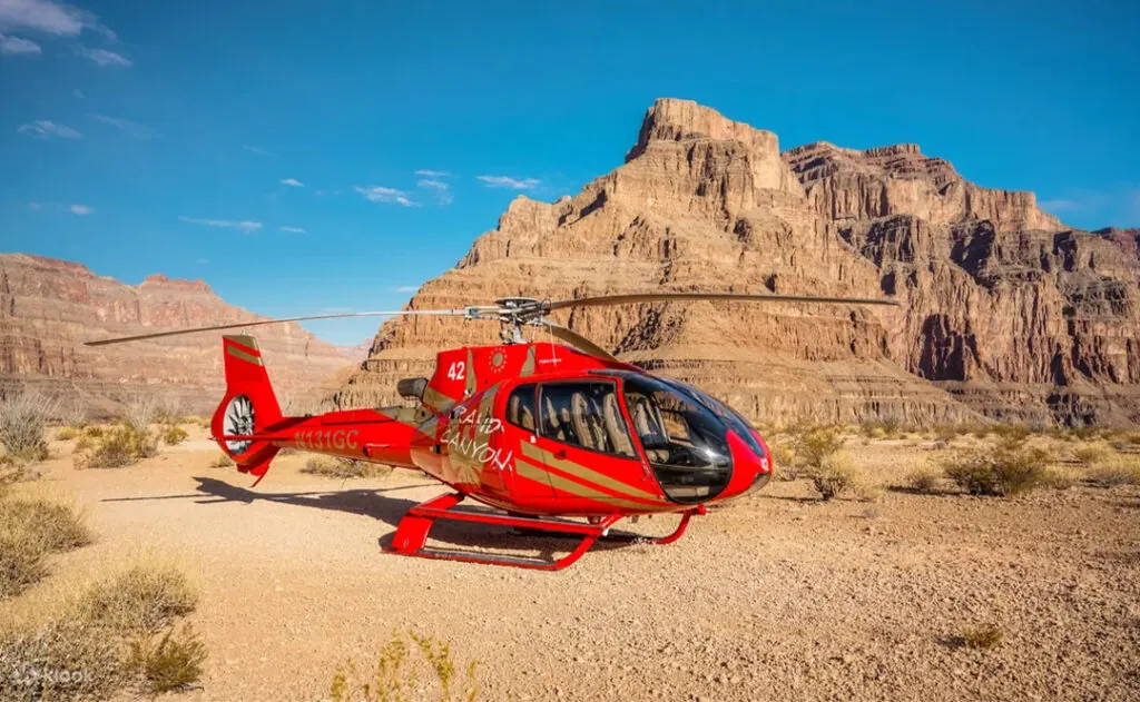 Red and gold helicopter in the grand canyon