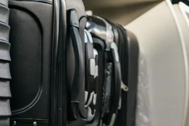 Luggage in overhead bin on airplane