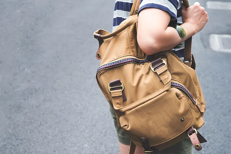 Close up of person carrying backpack