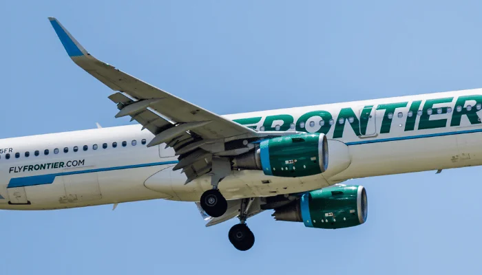 ORLANDO, FLORIDA - JUNE 29, 2022 : Frontier Airlines Airbus A321 commercial jet airplane in flight shortly before landing at the Orlando International Airport (MCO). Ferndale the Pygmy Owl jet plane.